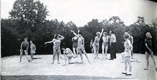 The first known photograph showing Balanchine working with American dancers on Serenade - June 1934, at White Plains. The women are scattered about, wearing bathing suits, daytime.