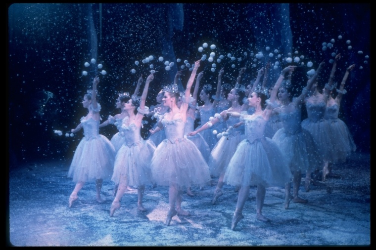 Corps de ballet in the Snow section of The Nutcracker, holding pompoms in the snow