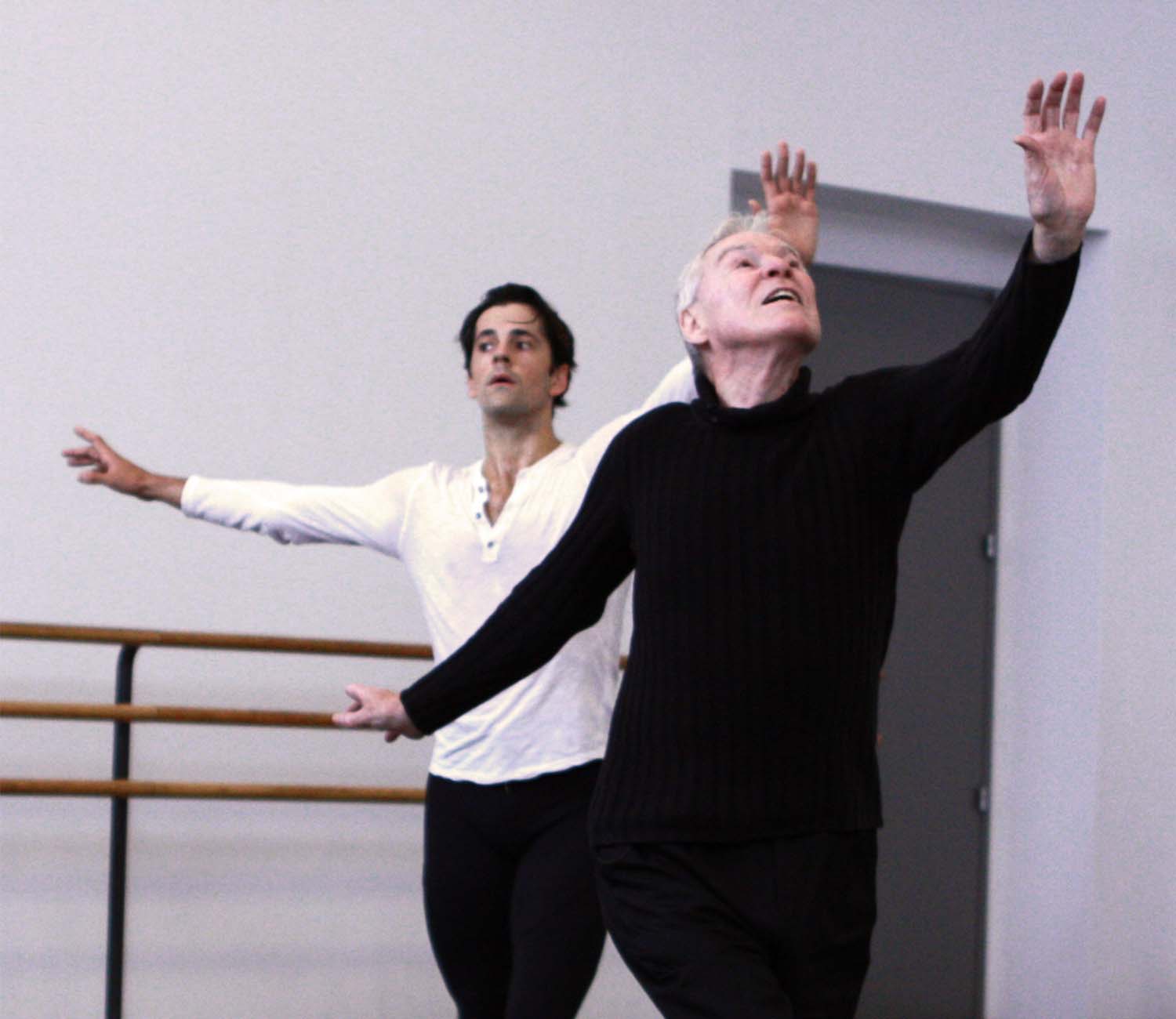 Robert Fairchild coached by Jacques d'Amboise, both looking up to one arm in a pose from Apollo