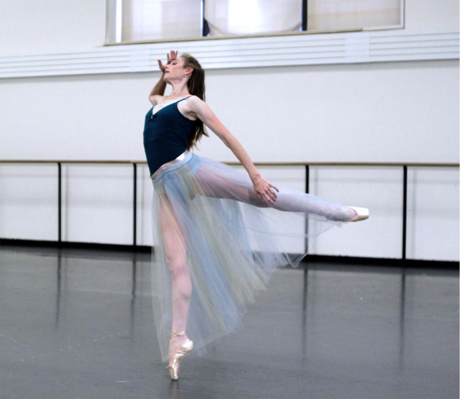 Ashley Laracey wearing a blue tulle skirt in an arabesque rehearsing Hermia in A Midsummer Night's Dream